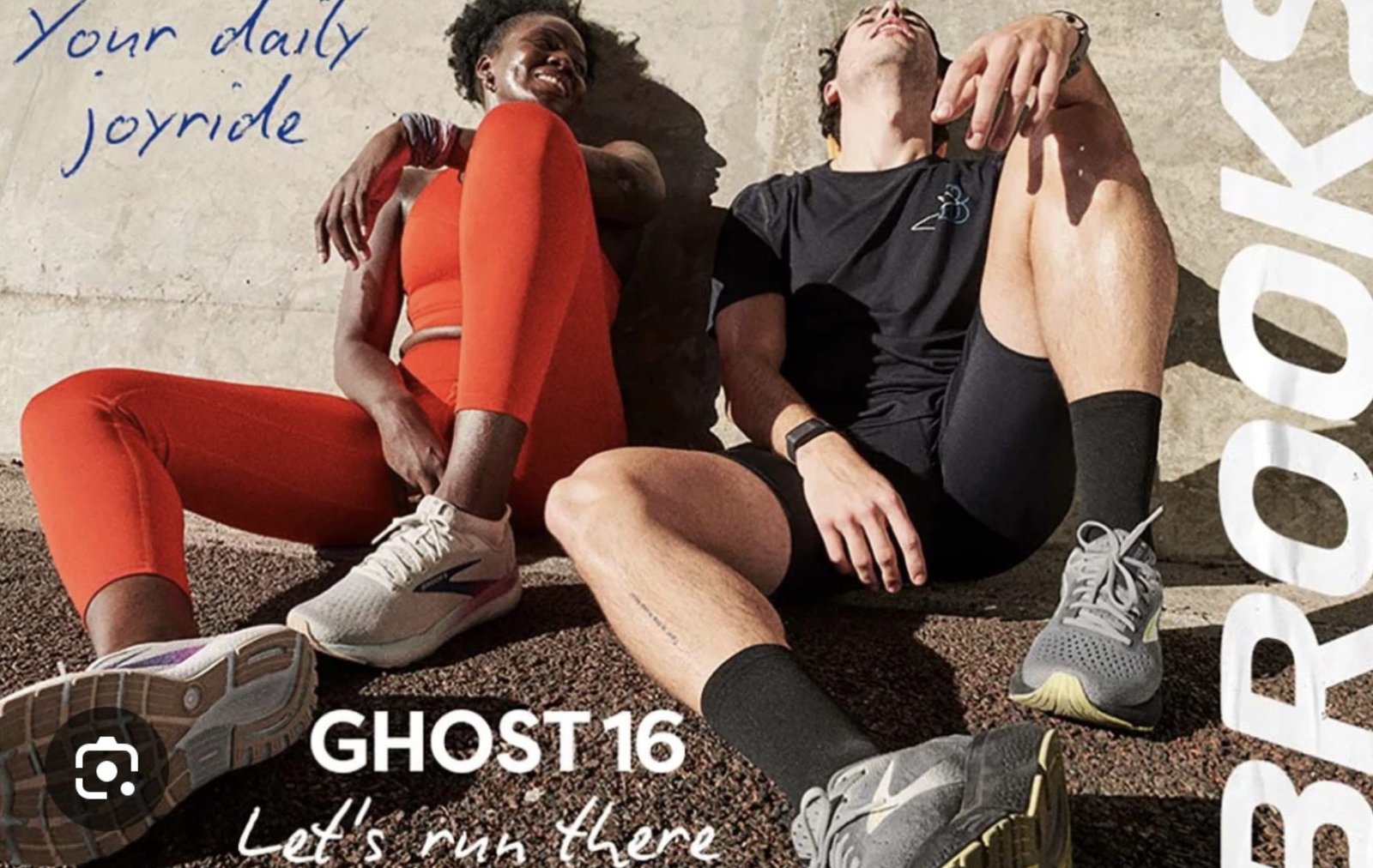 A man and woman sitting outdoors in athletic wear, featuring Brooks Ghost 16 running shoes. The image includes text that says "Your daily joyride," "GHOST 16," and "Let's run there" with a vertical Brooks logo.