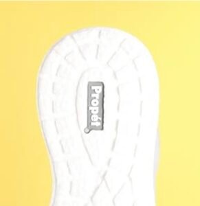 Close-up of the white high-traction outsole of a Propét sneaker, showing the wide stable base and slip-resistant tread patter