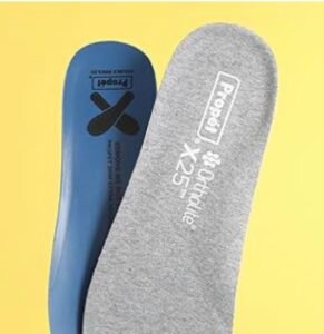 Propét X25 Ortholite double insole system showing the removable grey and blue cushioned inserts for customizable depth.
